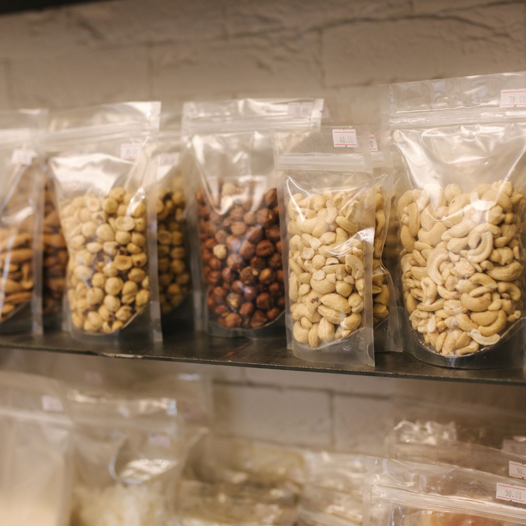 Healthy portable snacks including oatcakes, nuts, fruit and yoghurt packed for gut-friendly travel.